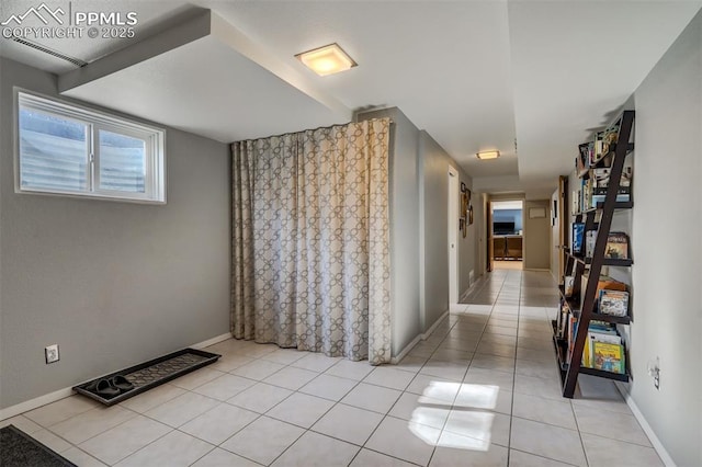 hall featuring light tile patterned floors