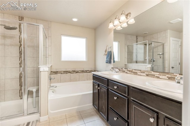 bathroom featuring plus walk in shower, tile patterned flooring, and vanity