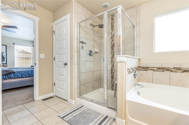 bathroom featuring tile patterned floors, ceiling fan, and independent shower and bath