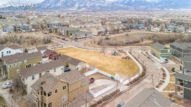 birds eye view of property with a mountain view