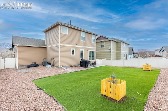 930 Antrim Loop, Colorado Springs, CO 80910 - back of house with a fenced backyard, central air condition unit, a lawn, and a patio