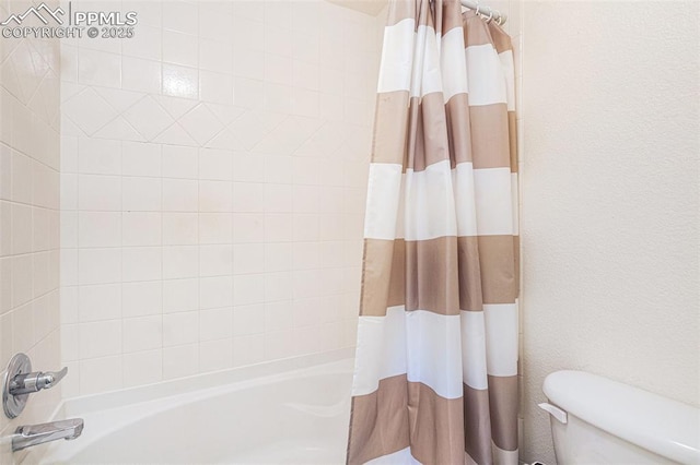 bathroom with toilet and shower / bathtub combination with curtain