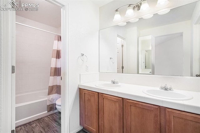 full bathroom featuring shower / tub combo with curtain, wood-type flooring, toilet, and vanity