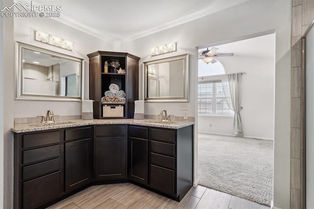 bathroom featuring vanity, ornamental molding, and ceiling fan