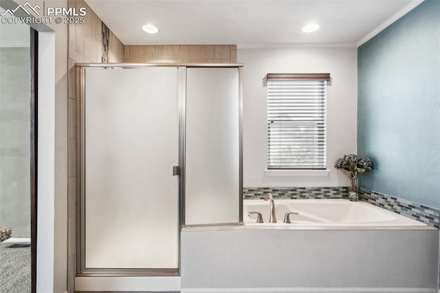 bathroom featuring independent shower and bath