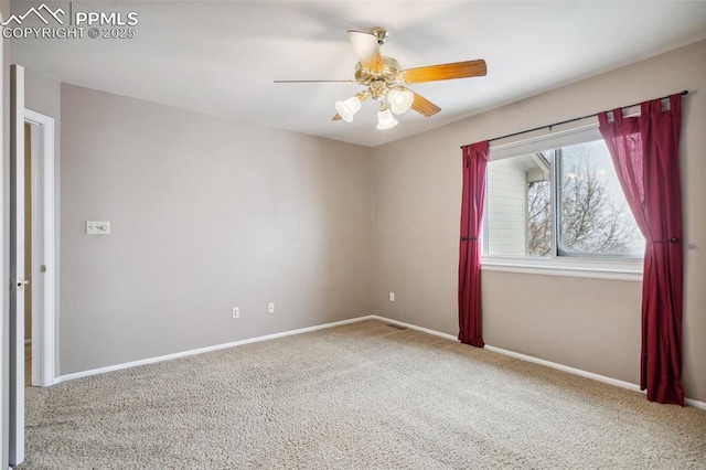 carpeted spare room with ceiling fan