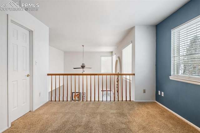 spare room featuring carpet and ceiling fan