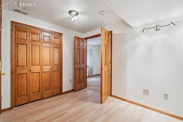 unfurnished bedroom with light wood-type flooring