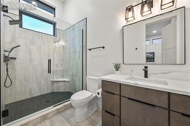 bathroom featuring vanity, toilet, and a shower with shower door