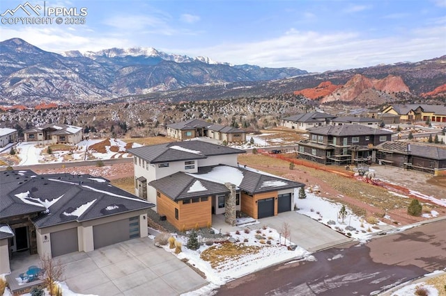 snowy aerial view featuring a mountain view