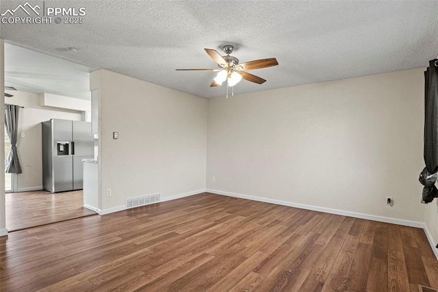 unfurnished living room with hardwood / wood-style floors, a textured ceiling, and ceiling fan