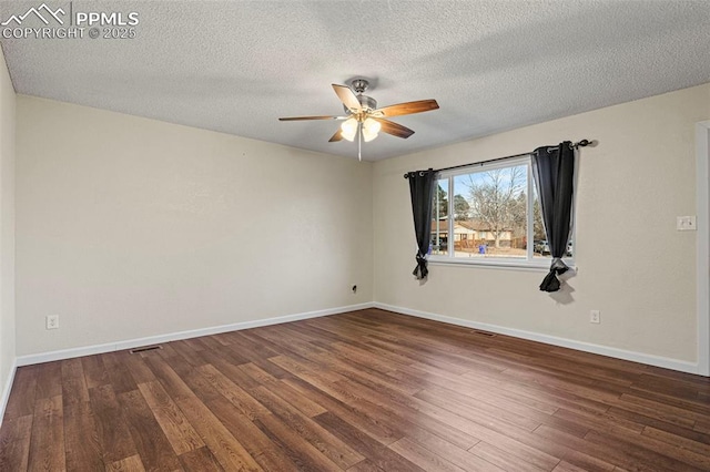 spare room with dark hardwood / wood-style flooring, a textured ceiling, and ceiling fan