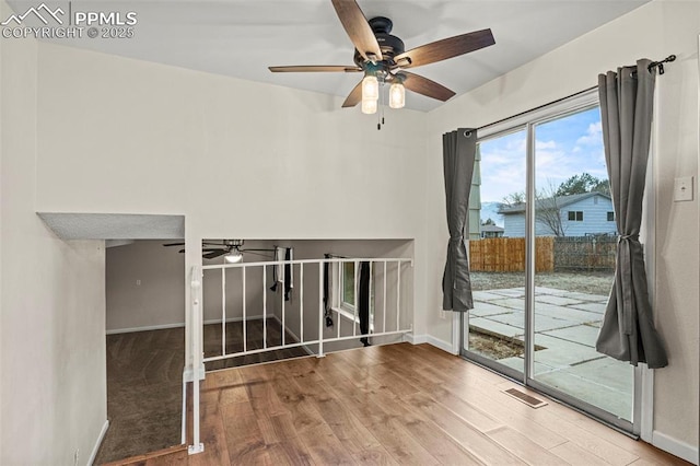 spare room featuring wood-type flooring and ceiling fan