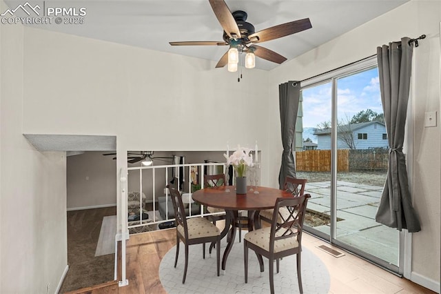 dining area with light hardwood / wood-style flooring and ceiling fan