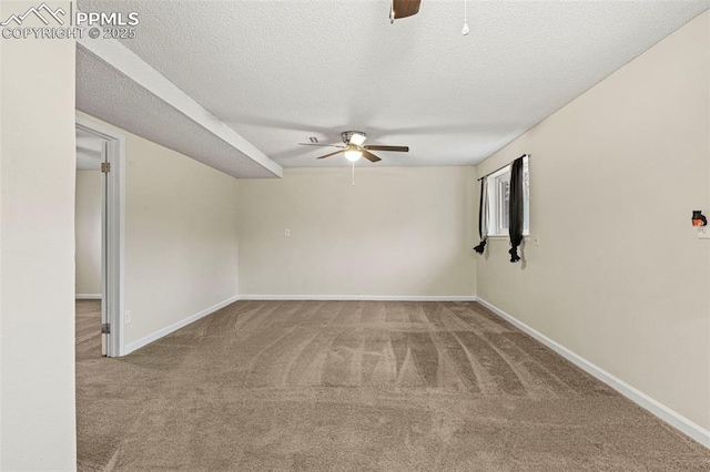 empty room featuring ceiling fan, carpet flooring, and a textured ceiling