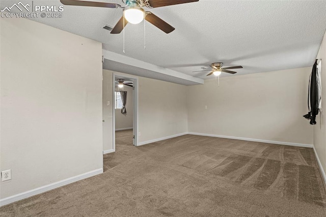 unfurnished room featuring light carpet and a textured ceiling