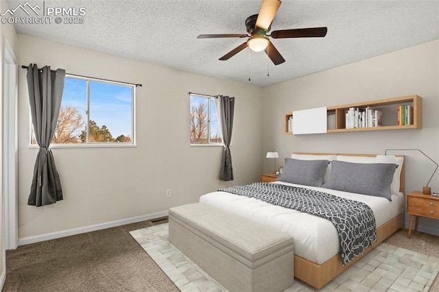 bedroom with ceiling fan, light carpet, and a textured ceiling