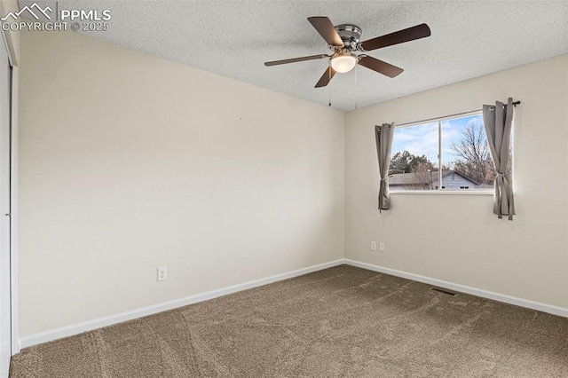 empty room with ceiling fan, carpet, and a textured ceiling