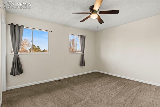 carpeted spare room with ceiling fan and a textured ceiling