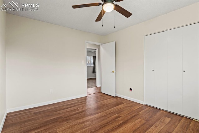 unfurnished bedroom featuring ceiling fan, hardwood / wood-style floors, and a closet