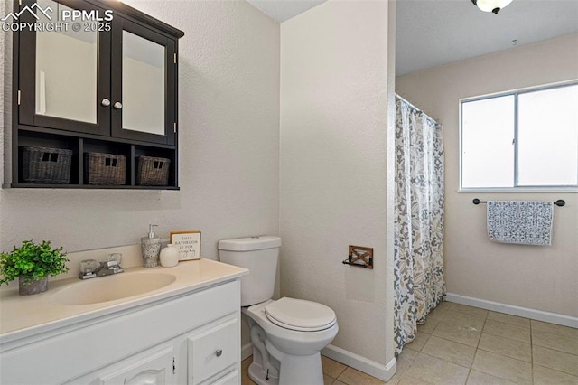 bathroom featuring vanity, tile patterned floors, and toilet