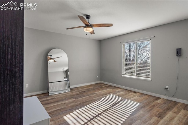 empty room featuring hardwood / wood-style flooring and ceiling fan