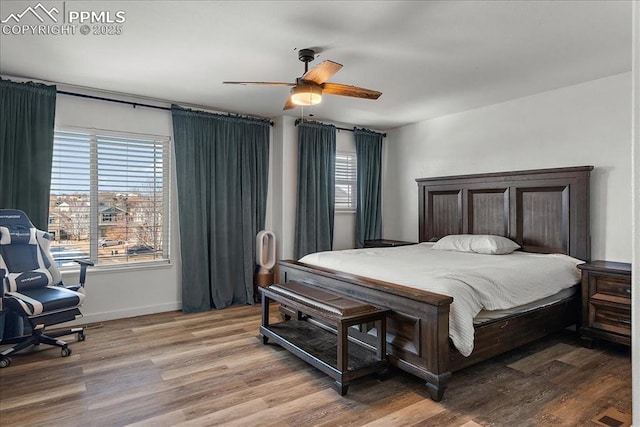 bedroom with wood-type flooring and ceiling fan