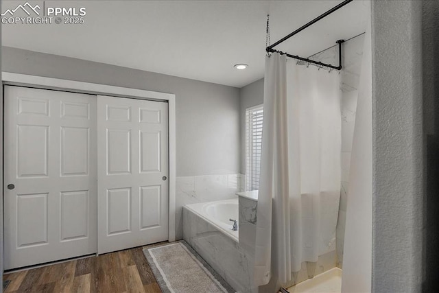 bathroom featuring hardwood / wood-style floors and shower with separate bathtub