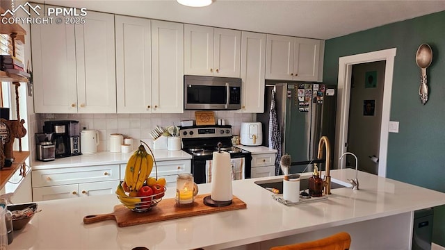 kitchen with stainless steel appliances and white cabinets