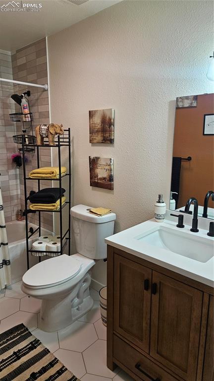 bathroom featuring vanity, tile patterned floors, toilet, and a shower with shower curtain