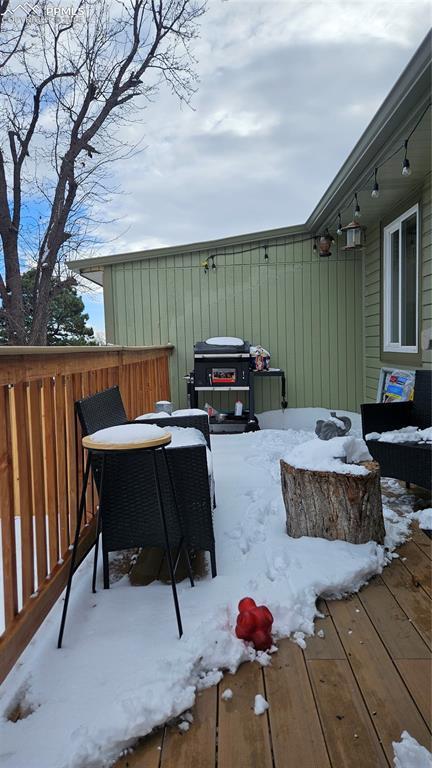 snow covered deck with area for grilling