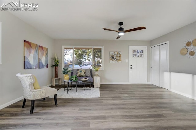 foyer entrance with wood finished floors, baseboards, and ceiling fan