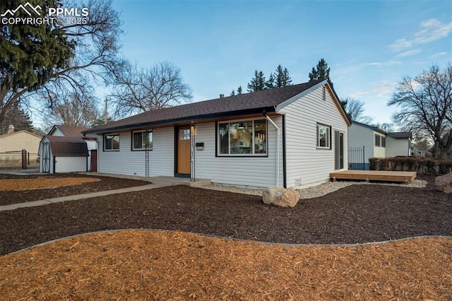 ranch-style house featuring a storage unit and an outbuilding