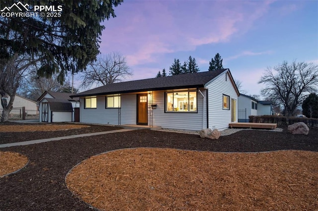 view of front of home with an outbuilding and fence