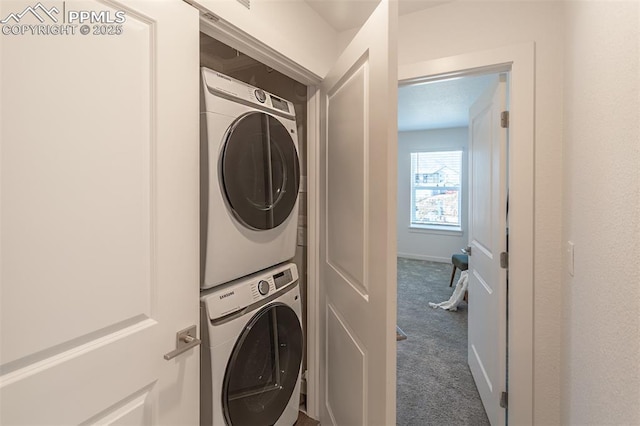 clothes washing area featuring stacked washer and dryer and carpet floors