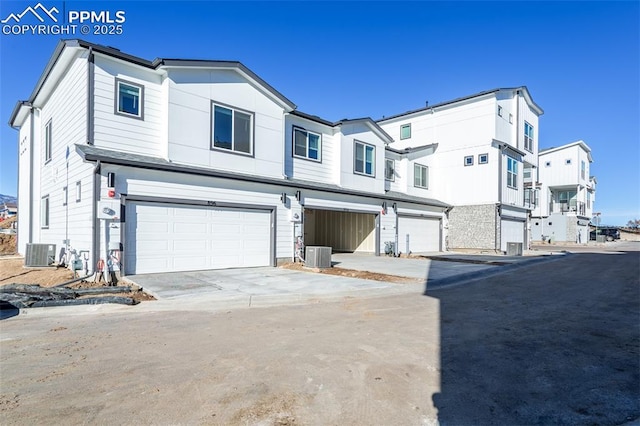 townhome / multi-family property featuring a garage and central AC