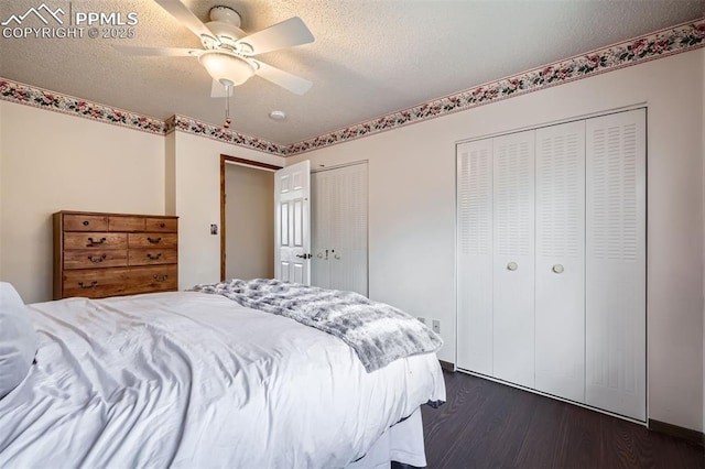 bedroom featuring dark hardwood / wood-style flooring, ceiling fan, a textured ceiling, and multiple closets