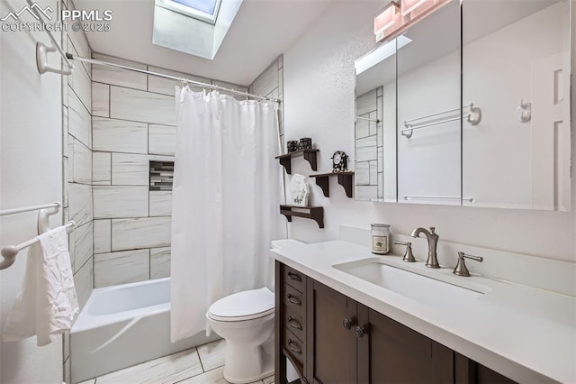 full bathroom featuring vanity, a skylight, toilet, and shower / tub combo with curtain