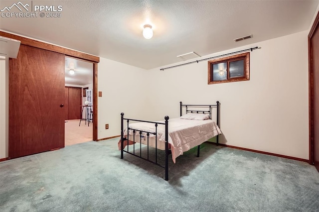 carpeted bedroom with a textured ceiling