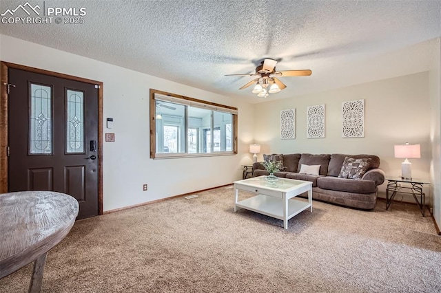 carpeted living room with a textured ceiling and ceiling fan