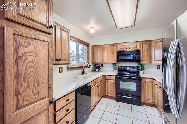 kitchen with sink, black appliances, and light tile patterned flooring