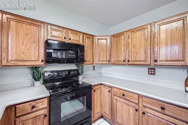 kitchen featuring light tile patterned floors and black appliances