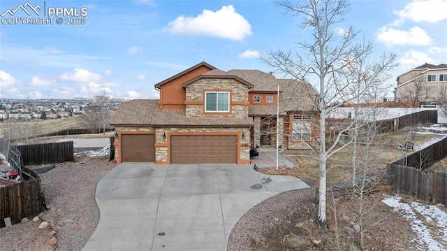 view of front of house with stone siding, fence, concrete driveway, and an attached garage