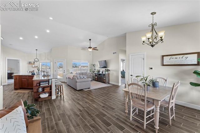 dining area featuring ceiling fan with notable chandelier and high vaulted ceiling