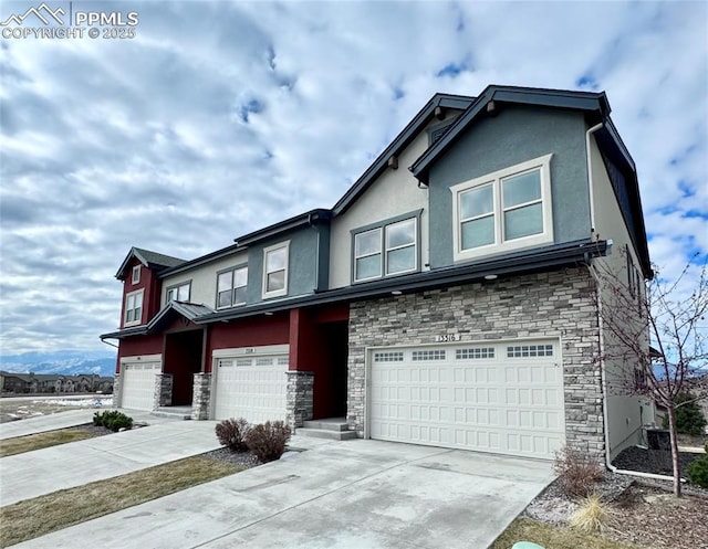 view of front of property featuring a garage and a mountain view