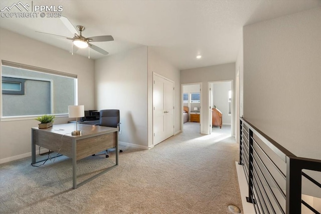 carpeted office featuring ceiling fan