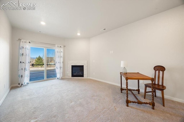 sitting room featuring light colored carpet