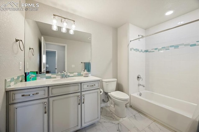 full bathroom with vanity, tiled shower / bath combo, and toilet