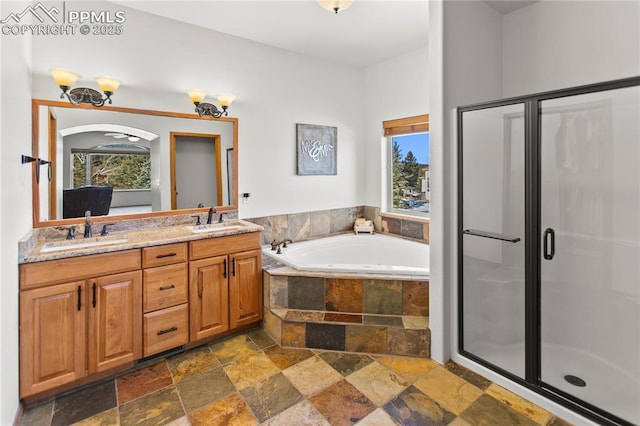 bathroom featuring a healthy amount of sunlight, vanity, and separate shower and tub