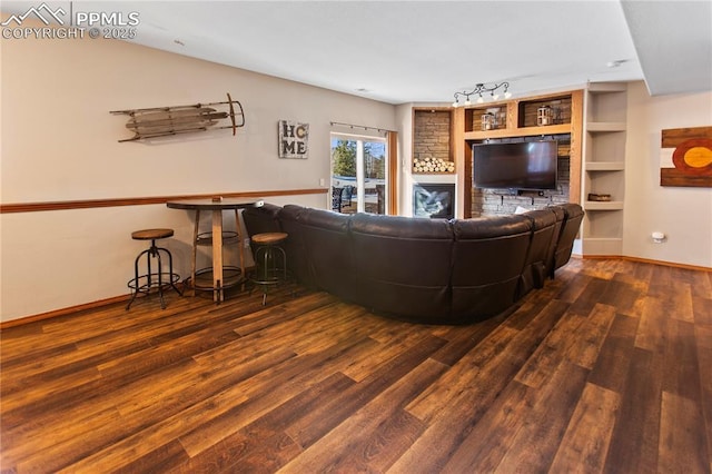 living room featuring track lighting and dark hardwood / wood-style flooring